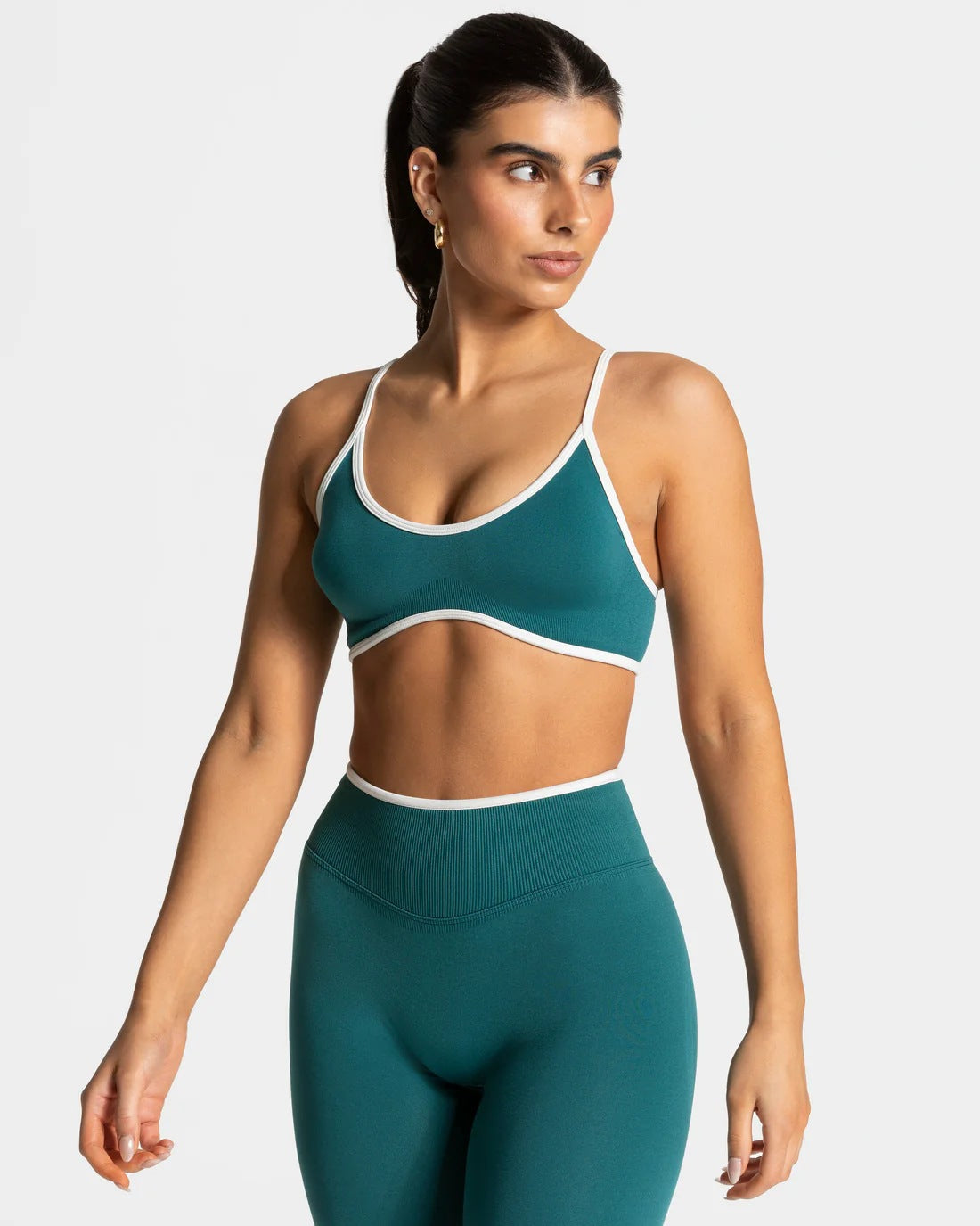 Matching scoop bralette and high-waisted leggings in the seamless yoga set, front view