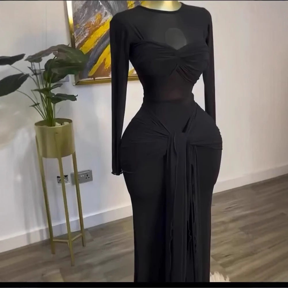 Black long sleeve maxi dress on a mannequin, close view of the twisted bust and front drape