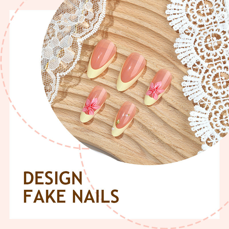 Close up of accent nails with a raised pink flower and faux pearl beads