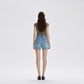 Back view of light blue denim shorts showing patch pockets and frayed hem