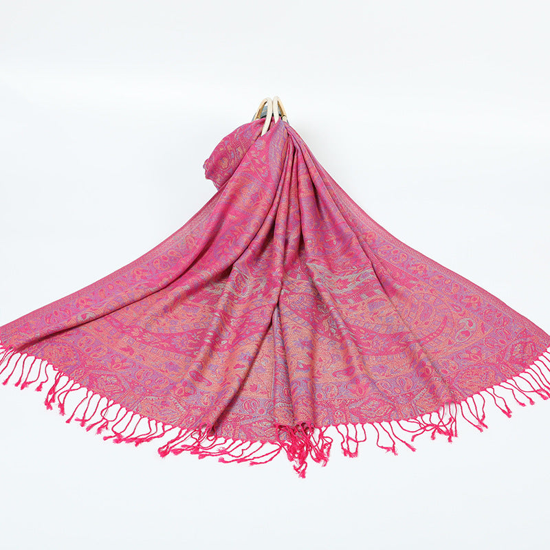 Rose red paisley shawl with a gold and lilac border and rose tassels spread on a white background