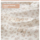 Close view of cream floral fabric with tiny bear motifs and the ruffle doll collar of the top