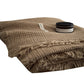 Tan cotton gauze blanket folded with a black jar on top, close view of the waffle weave and fringed edge