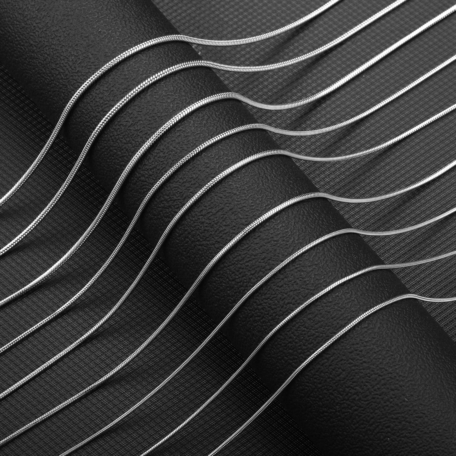 Macro detail of the polished stainless steel snake bone chain texture
