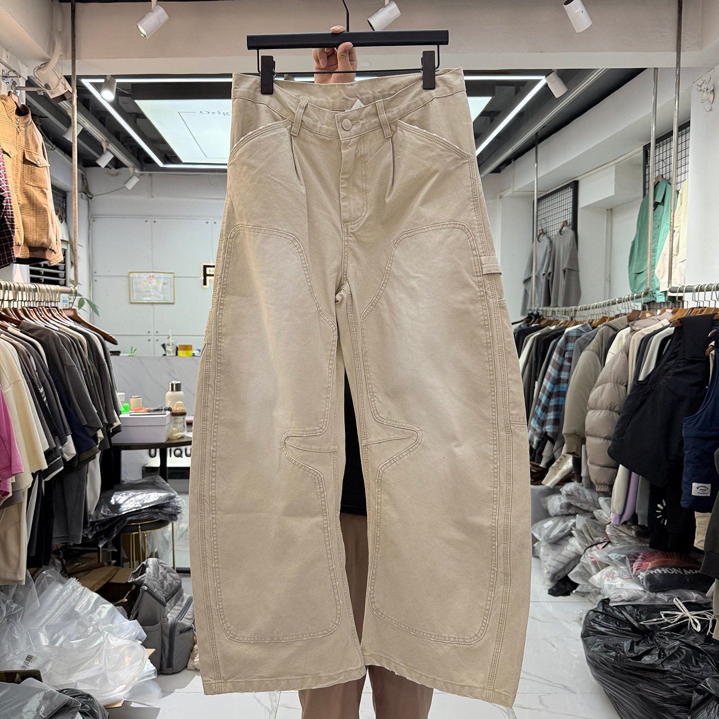 Men's cream wide leg carpenter pants front view on hanger with double-knee panels