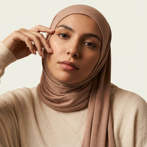 Solid tone modal cotton headscarf wrap laid in soft folds showing the fine jersey knit surface
