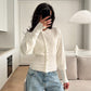 Model wears the rib knit cardigan buttoned down the front with the fitted waist visible