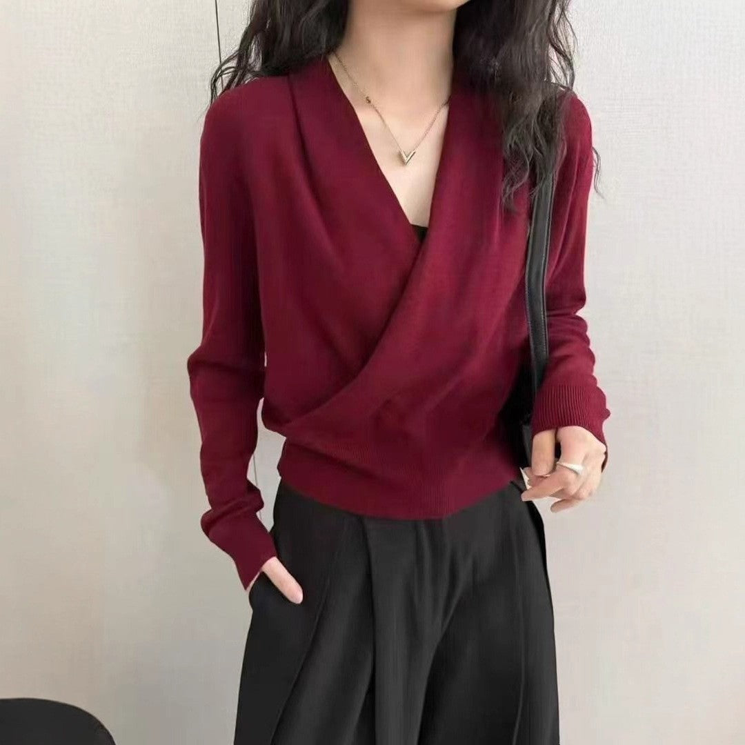 Dark gray crossover V-neck knit sweater on a hanger showing the fine knit texture