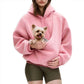 Model holding a small dog inside the pouch of the sky blue plush fleece hoodie