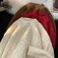 Brown, red, and cream heavyweight knit pullovers stacked to show the basketweave texture