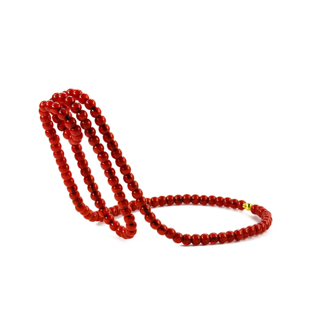 Red beaded wine bottle holder on a white background, Red option