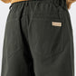 Close view of green pants with a back pocket, woven BEXDXS label and elasticated back waistband