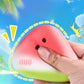 Butter yellow fruit squishy toy with a printed happy face resting on a light surface