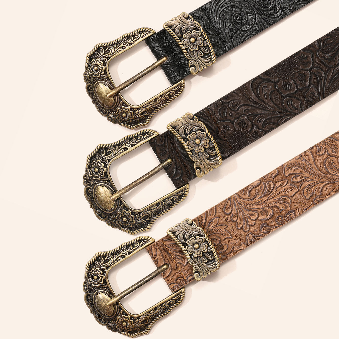 Black western floral embossed PU belt with an ornate antique brass pin buckle laid flat