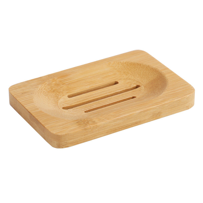 Rectangular bamboo soap dish with three drainage slots on a white background