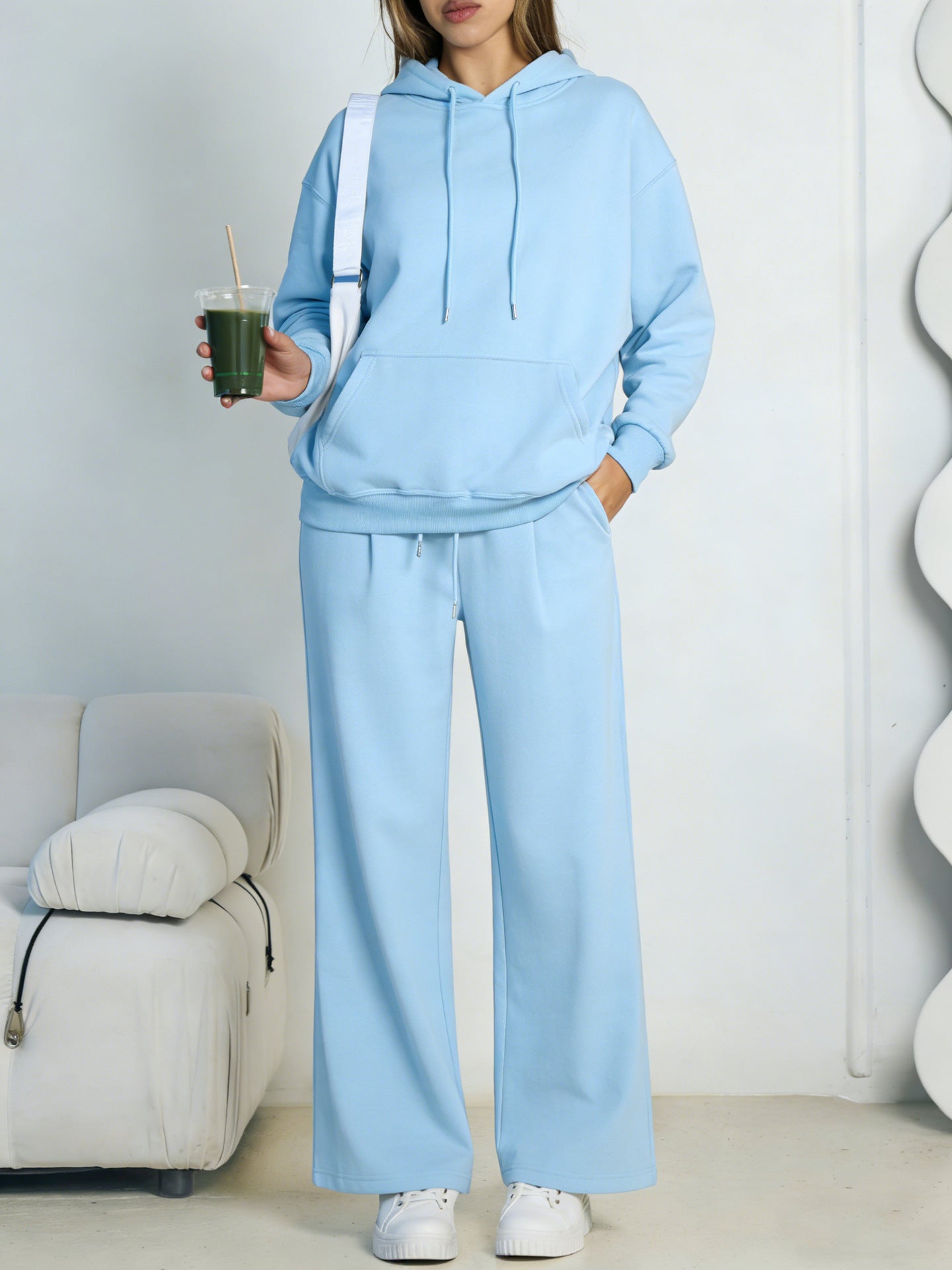 Light blue fleece hooded sweatshirt and wide-leg sweatpants set worn by a model
