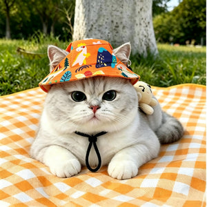 Pet bucket sun hat with ear holes and chin cord in an orange dinosaur print