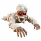 Halloween crawling mummy with skull face and frayed white bandages red eyes