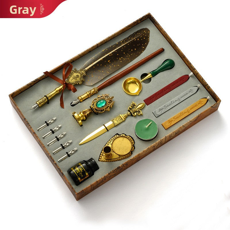 European style feather dip pen with a stainless steel nib, gold flecked resin barrel and ornate gold tone grip