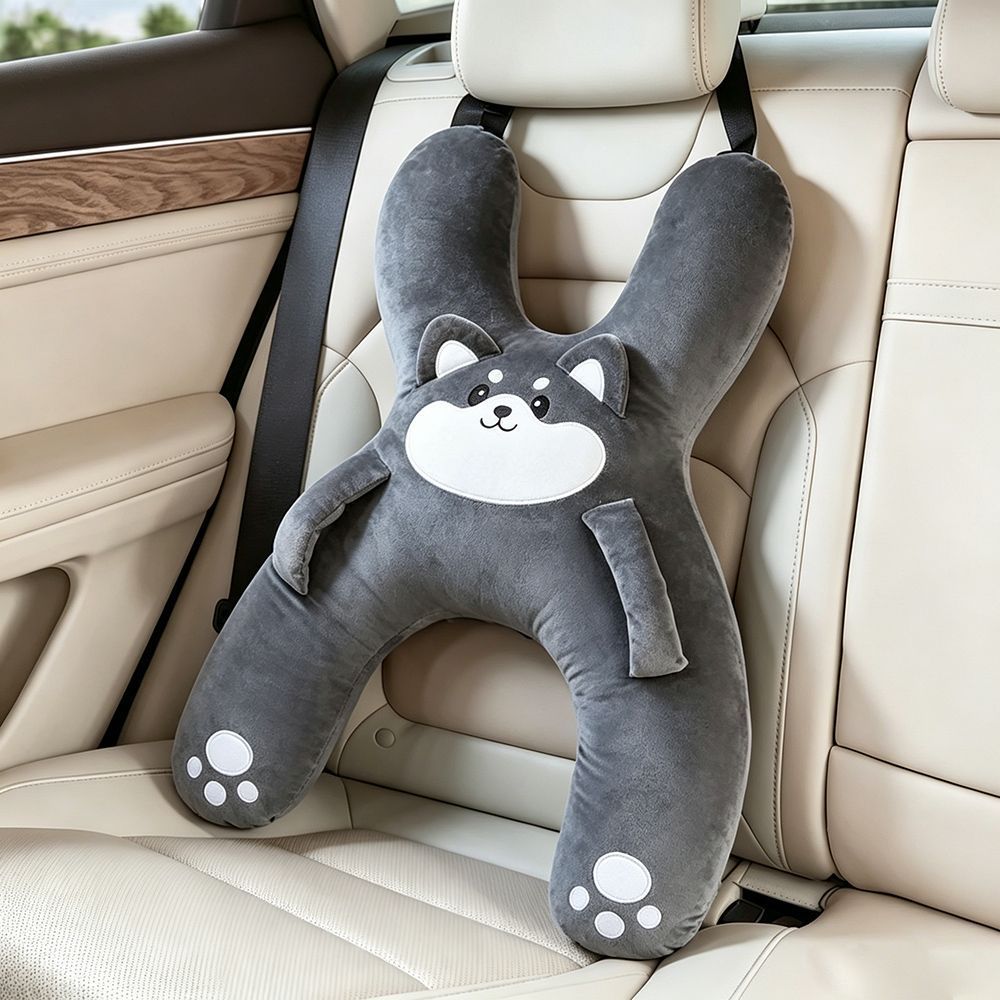 Padded arms of an animal car nap pillow resting over a car lap belt
