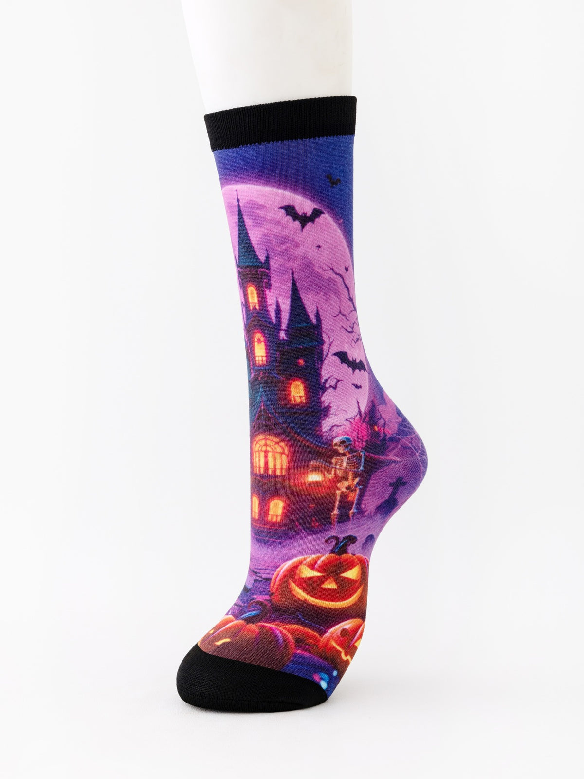 Mid-calf sock on a mannequin printed with a purple haunted castle, bats and a glowing pumpkin