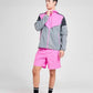 Man wearing a pink and grey colour block sports jacket with matching pink running shorts
