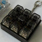Nine key smoke black keycap grid clicker with a four key unit and keyring