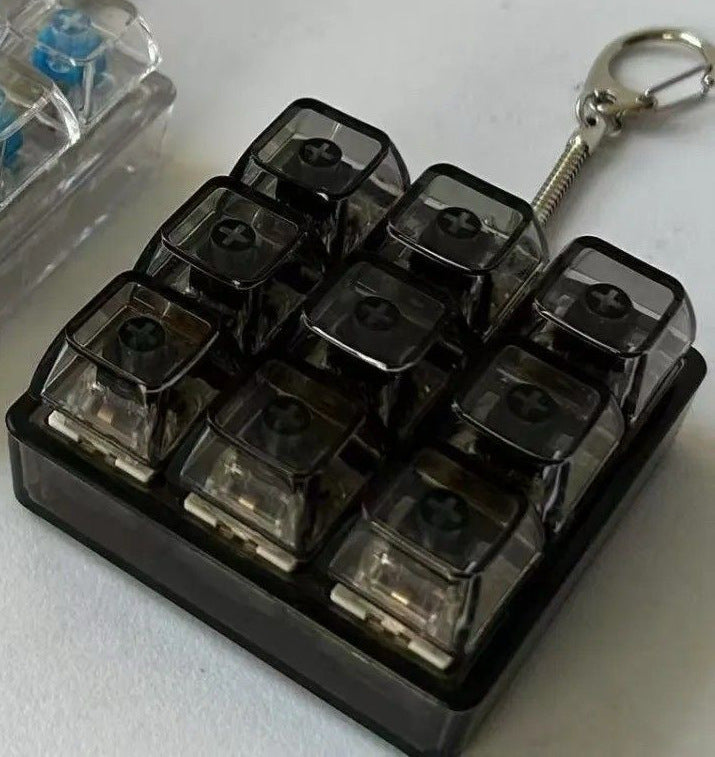 Nine key smoke black keycap grid clicker with a four key unit and keyring