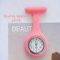 Rose red silicone nurse fob watch with a small round analog dial, angled view
