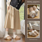 Woman wearing tweed look slippers with a faux fur cuff beside two close up photos of the slippers