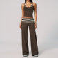 Model in a cropped camisole and wide leg fold over waist pants set, brown with mint and cream stripes