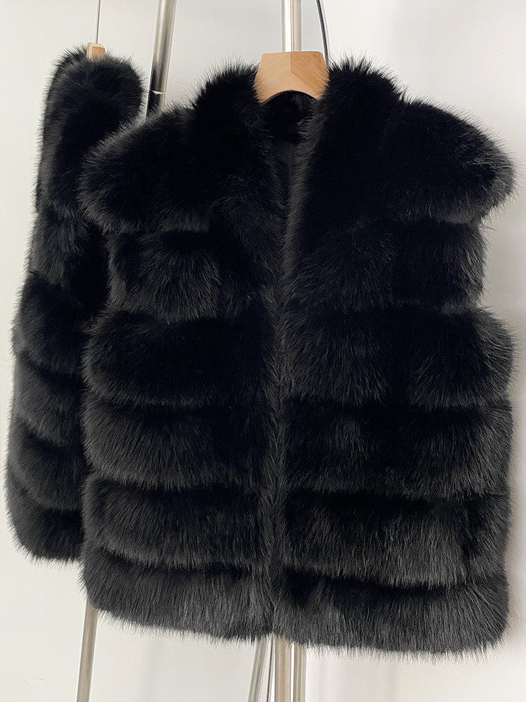 Black tiered vegan fur sleeveless vest on a wooden hanger with a wide V collar and open front