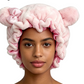 Model wearing the Strawberry Milk Pink bear ear sleep cap with a satin bow, front view