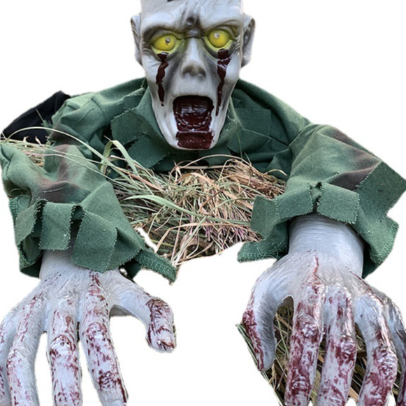 Animated crawling monster prop torso with clawing arms in a tattered green cloth body