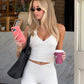 Cream white halter top and high-waist shorts set worn by a model outdoors