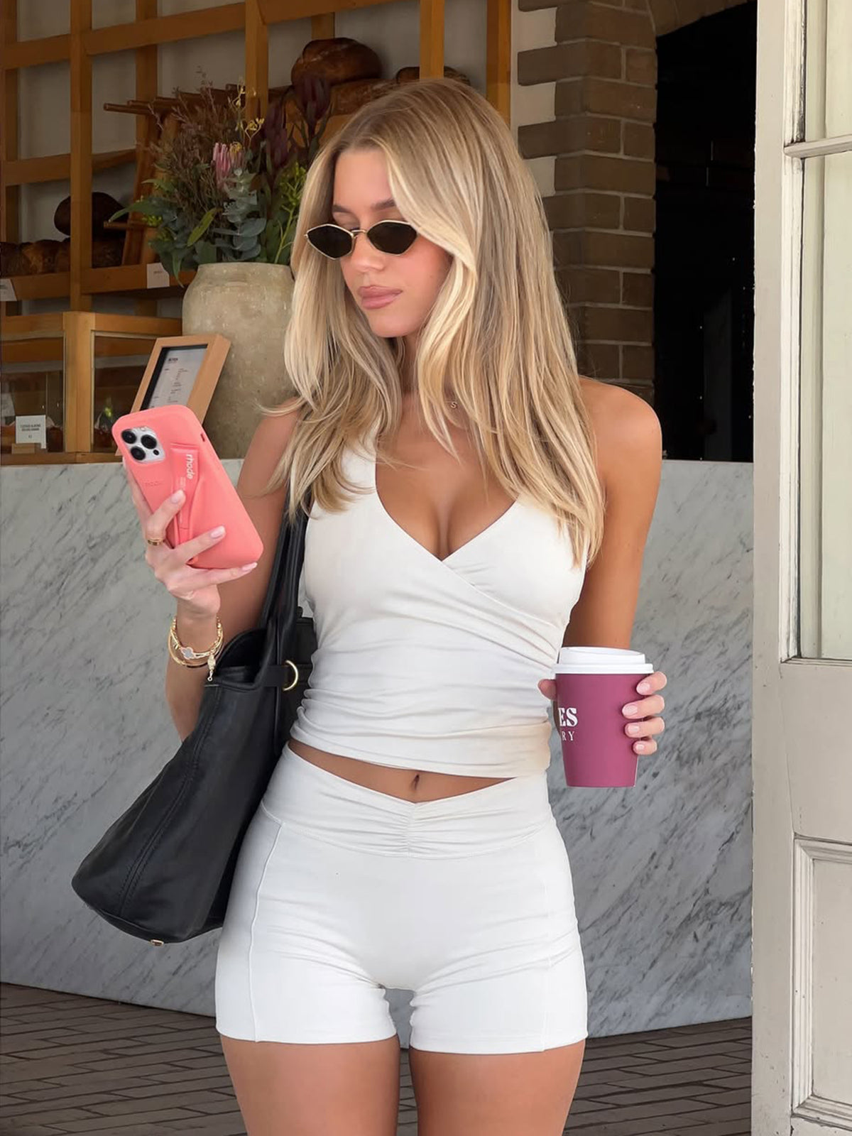 Cream white halter top and high-waist shorts set worn by a model outdoors