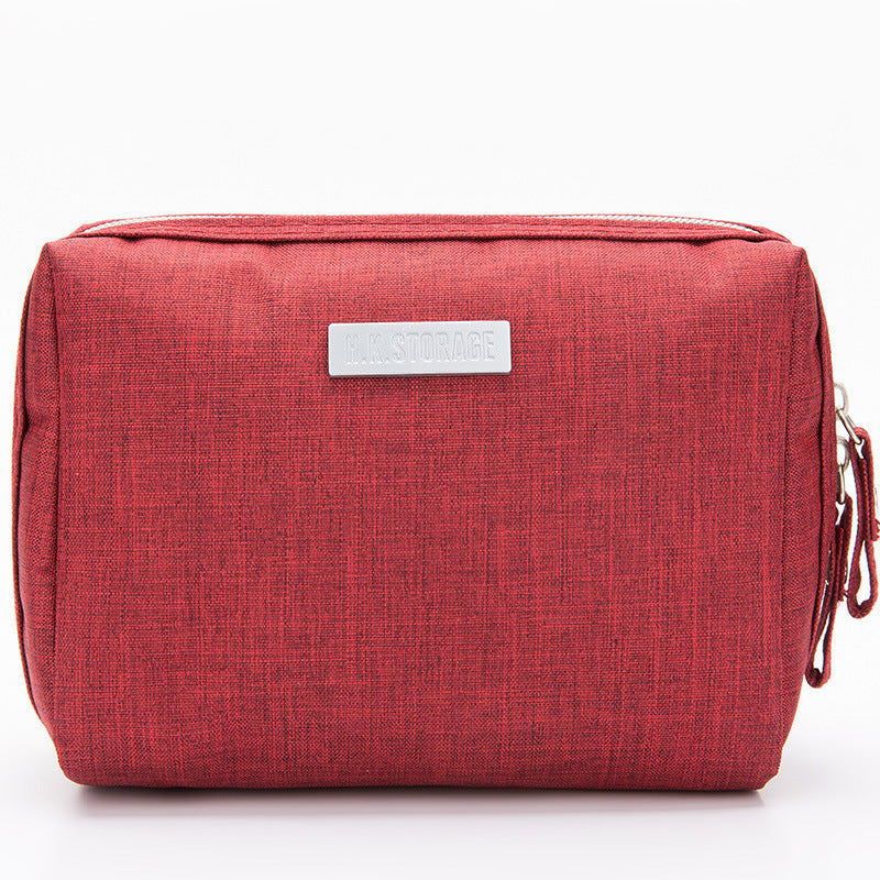 Cube shaped travel toiletry and cosmetic bag with a lined interior and grab handle