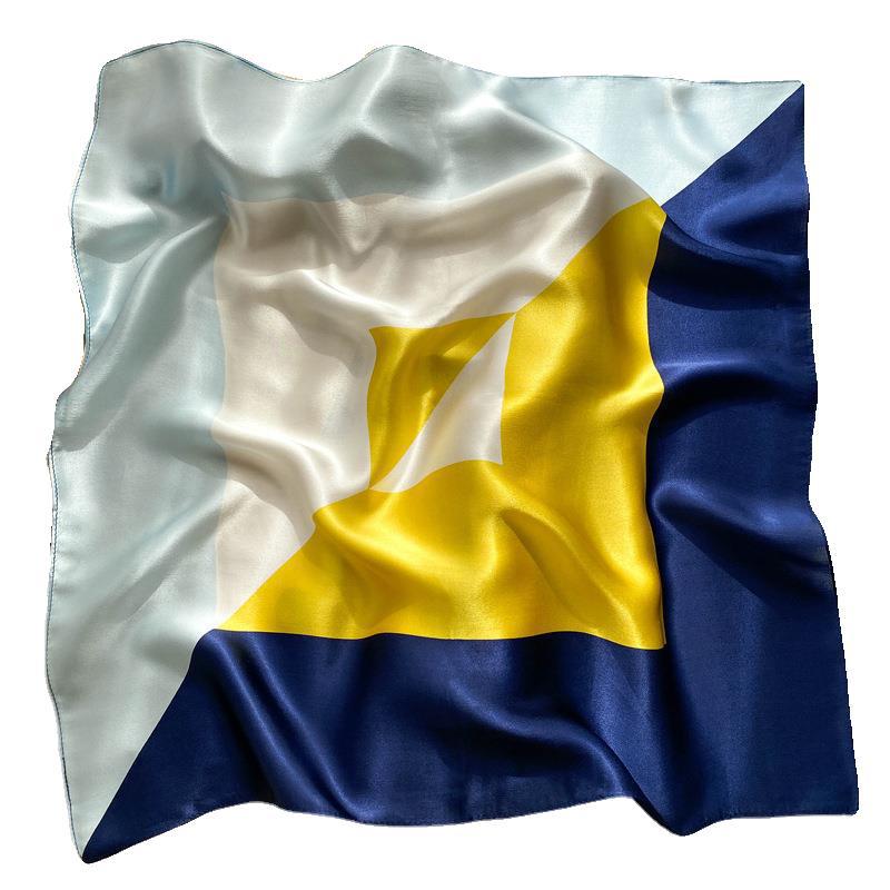 Light blue navy and yellow color block printed square scarf with a satin sheen and hemmed edges, shown displayed