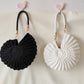 Handmade Woven Conch Shell Coin Purse | scale reference with hand