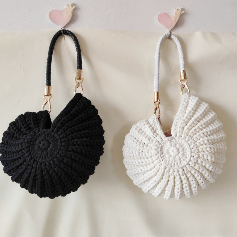 Handmade Woven Conch Shell Coin Purse | scale reference with hand