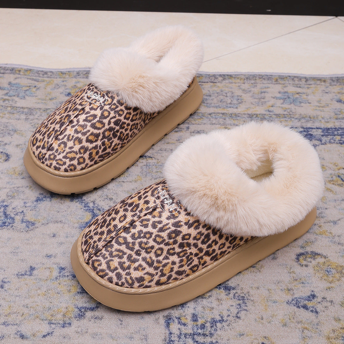 Close up of the faux fur collar and stitched suede look upper of a winter slipper