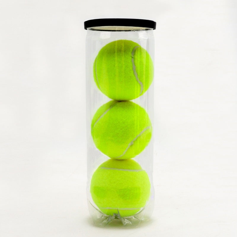 Clear tube holding three optic yellow green padel balls with a black lid on a pale background