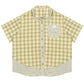 Green plaid short sleeve doll collar shirt on a clean studio background