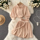 Close-up of the lightweight woven fabric on the shirt and skirt set