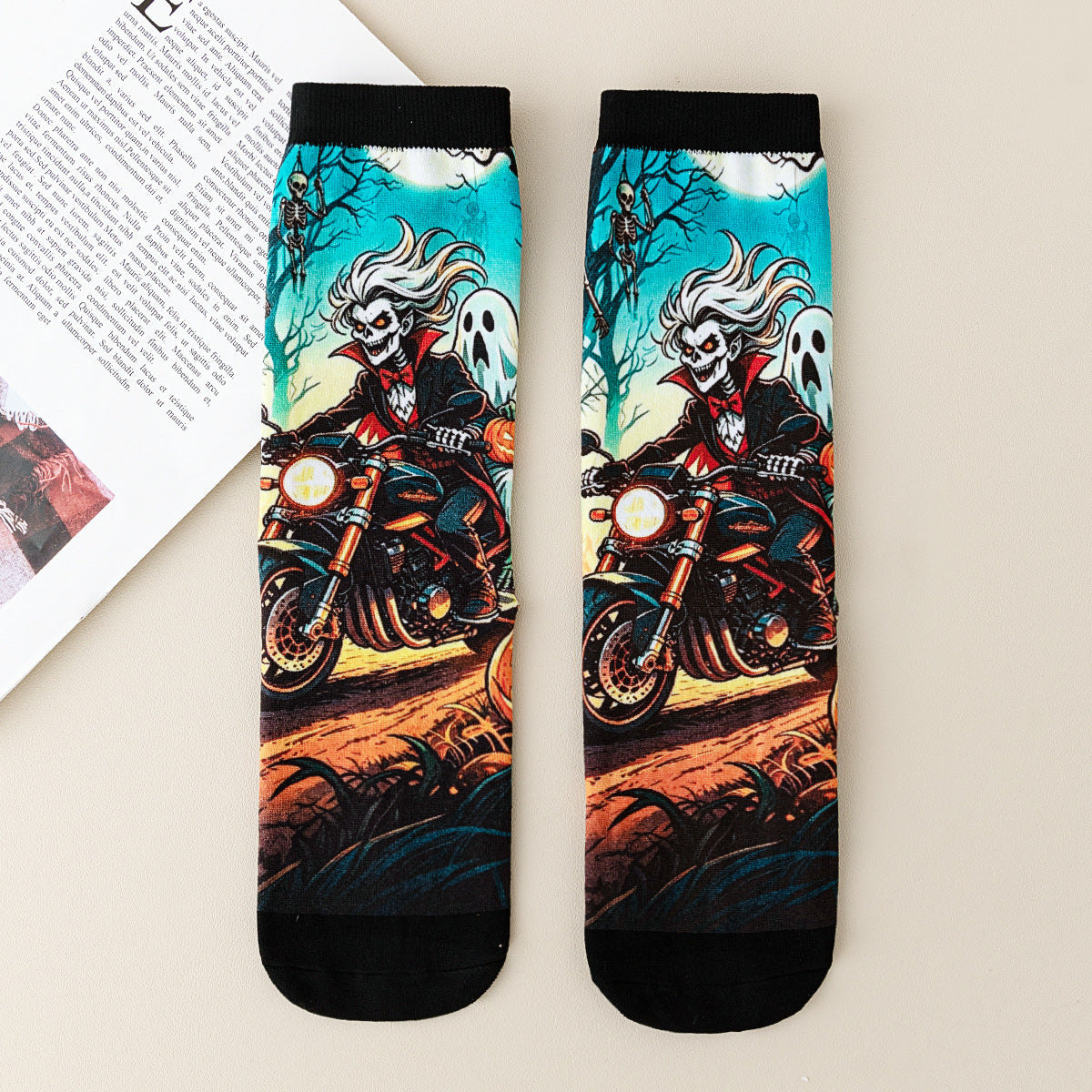 Pair of mid-calf socks printed with a skeleton motorcycle rider and a ghost on a teal ground