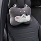 Gray dog headrest pillow with a spiral cheek mark shown alone on a black car seat