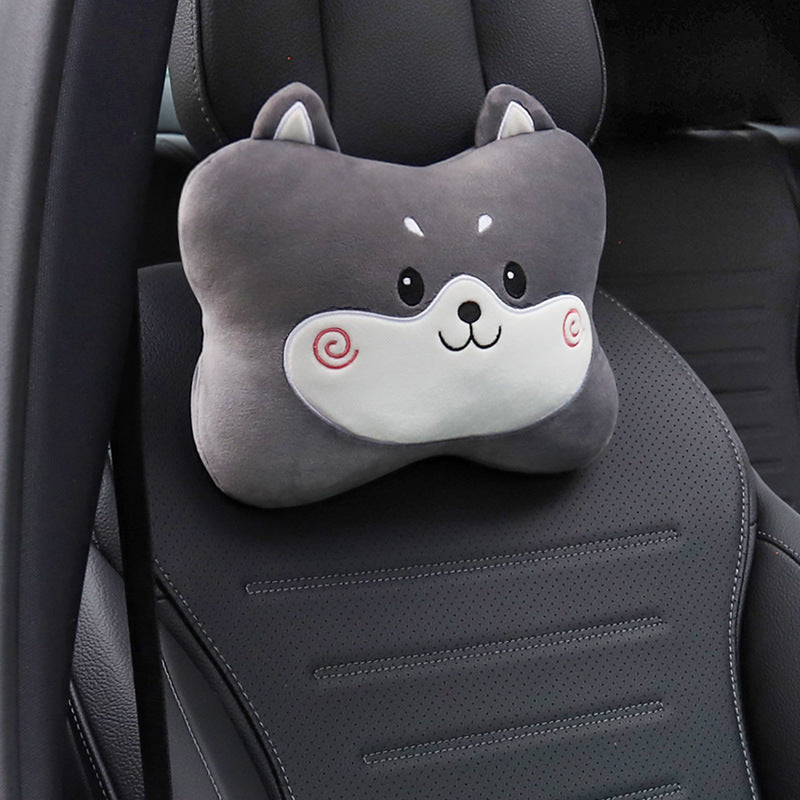 Gray dog headrest pillow with a spiral cheek mark shown alone on a black car seat