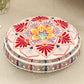 Round cushion with a red and pink lotus mandala print on a cream top and a pink striped side