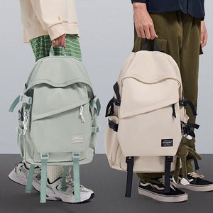 Simple polyester laptop backpack with a front flap pocket and curved shoulder straps shown on a model