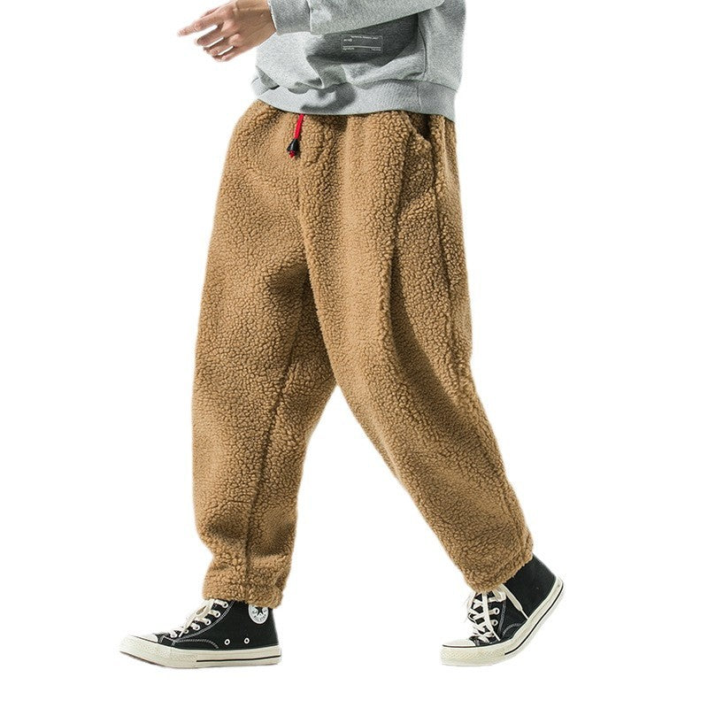 Camel brown plush harem pants shown walking on a white background with a gray sweatshirt